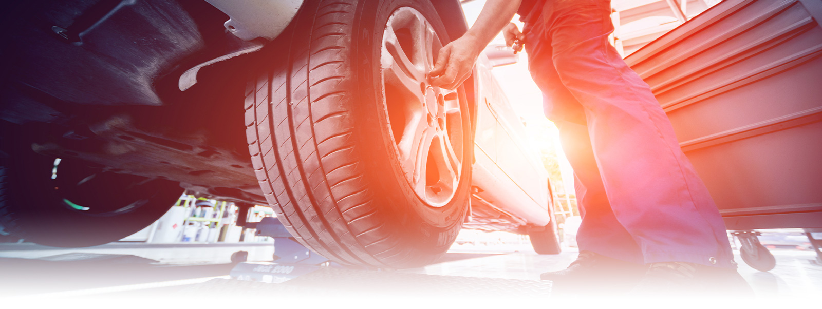 Auto Mechanic working on car tires